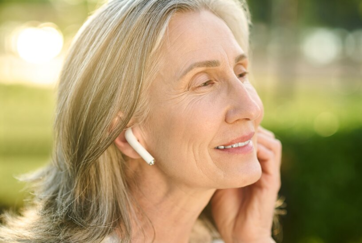 A mother using earbuds