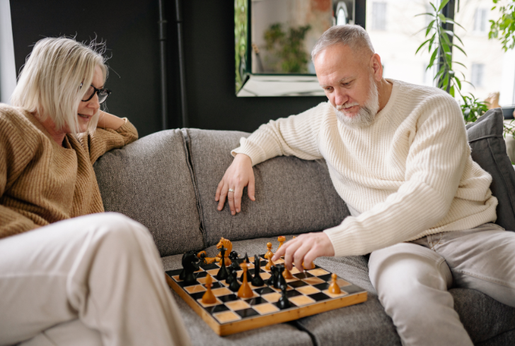 Older couple playing chess together